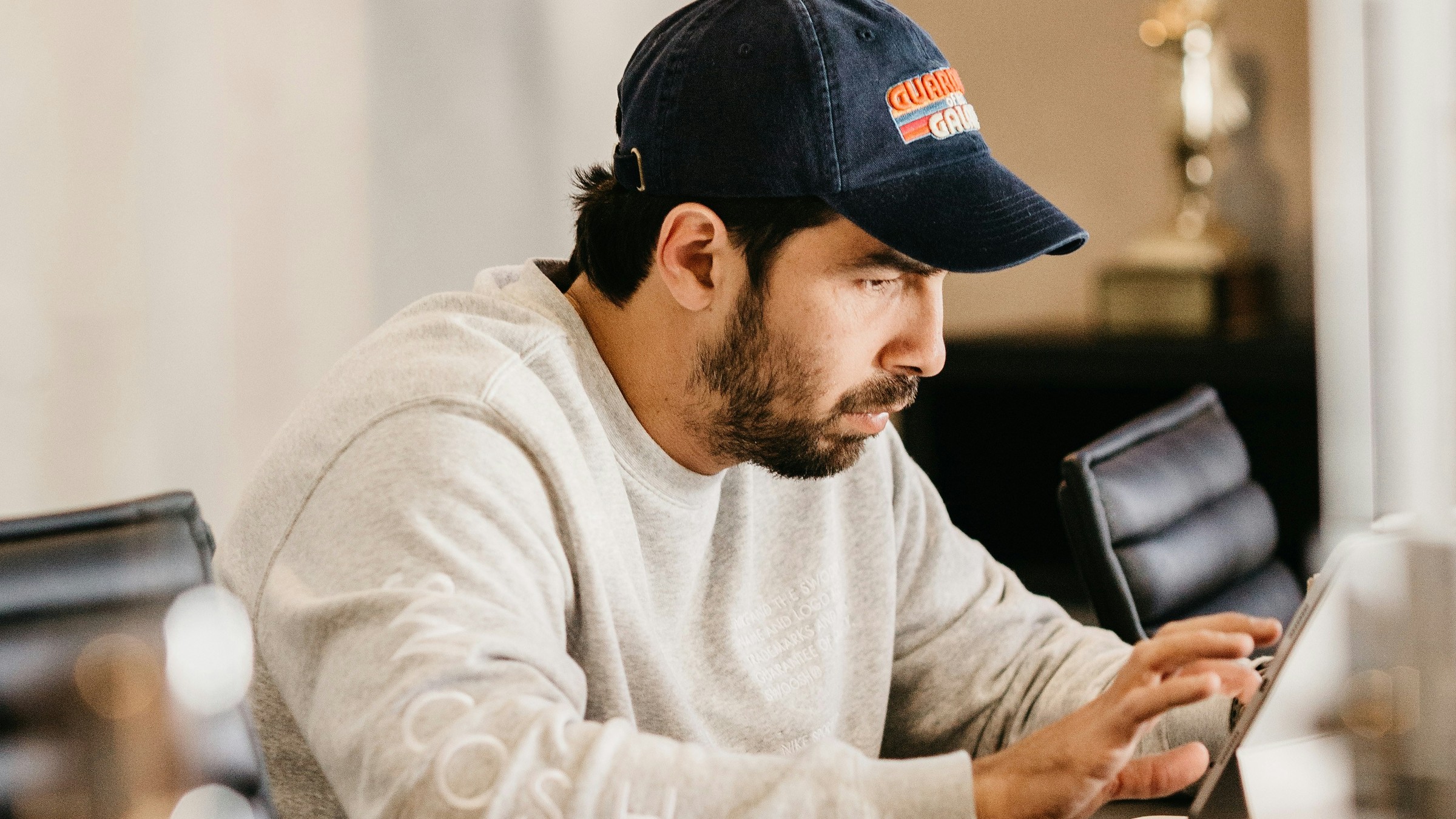 A person managing content and replying to messages on a tablet